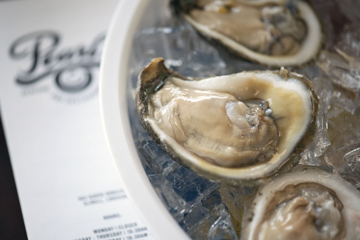 Raw oysters on the half shell at Pearl's Seafood in Slidell, photography by Cerberus Agency